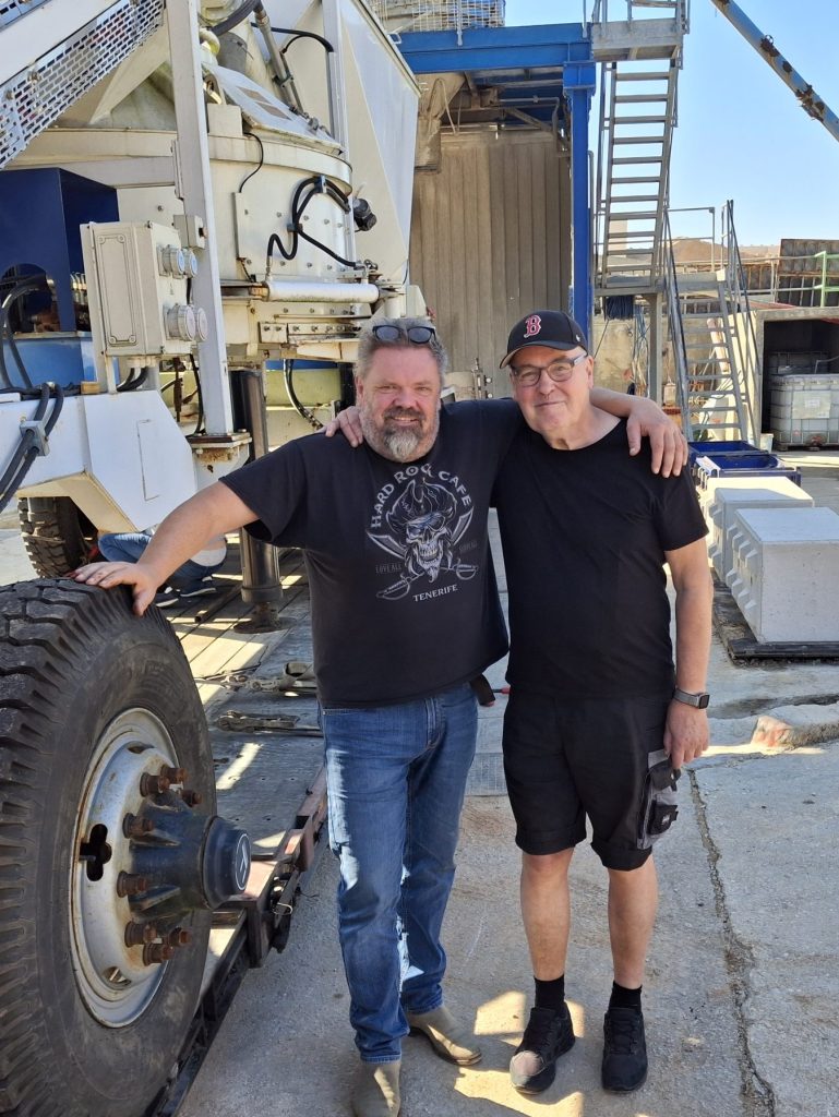 Two colleagues by a concrete truck