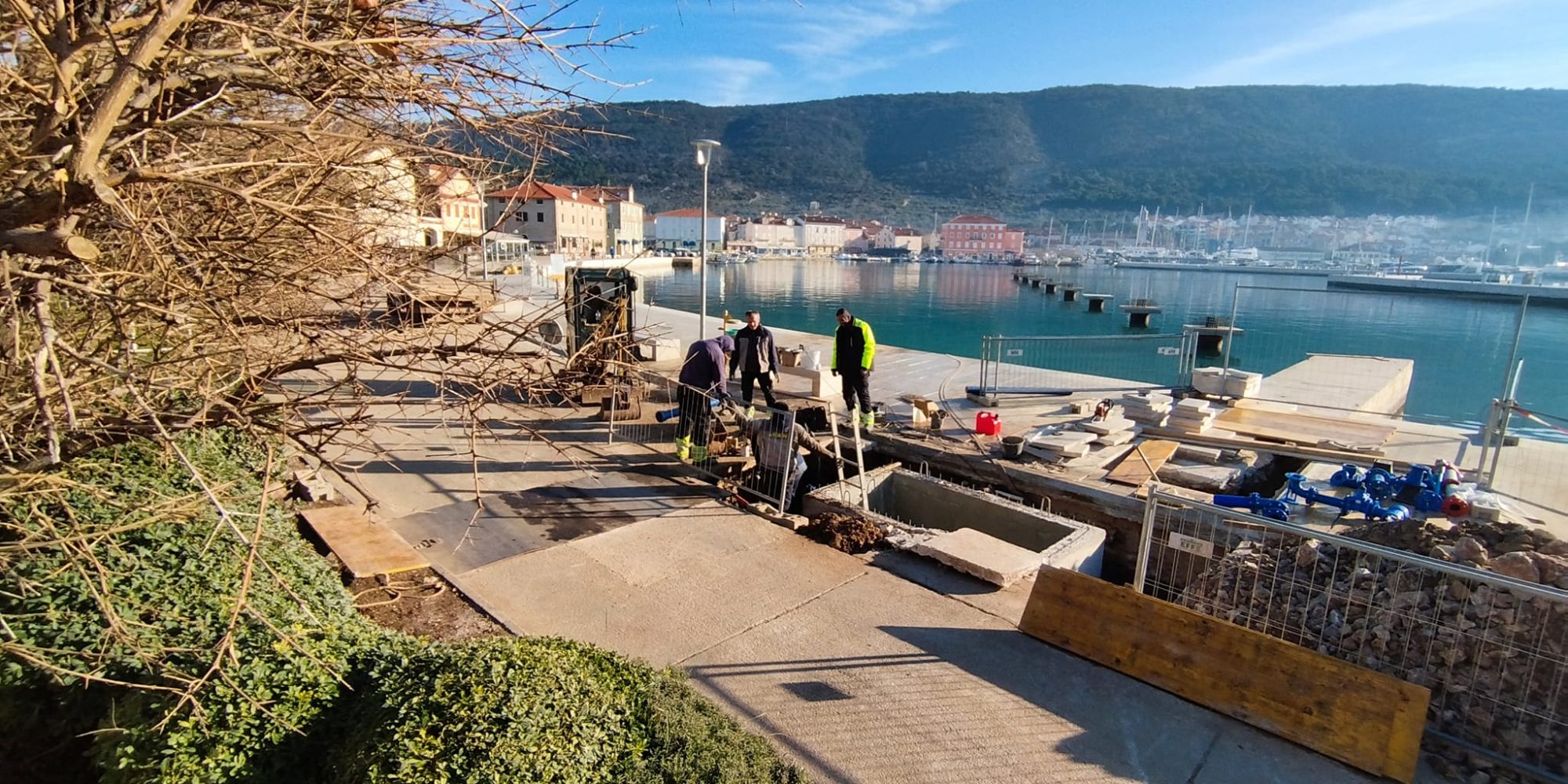Workers constructing a waterfront walkway